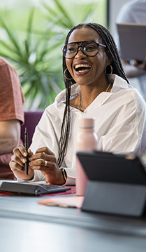 a woman smiling at a computer
