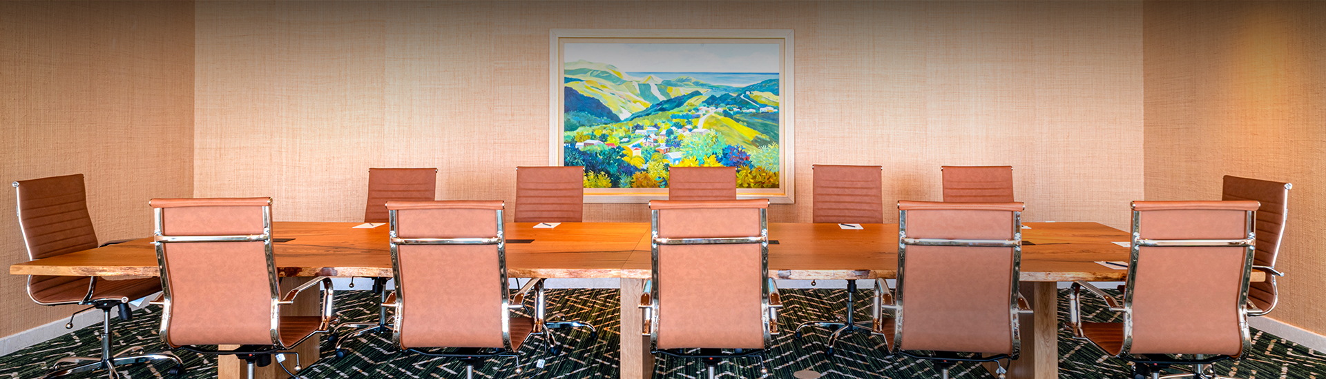 a conference room with chairs and a painting on the wall
