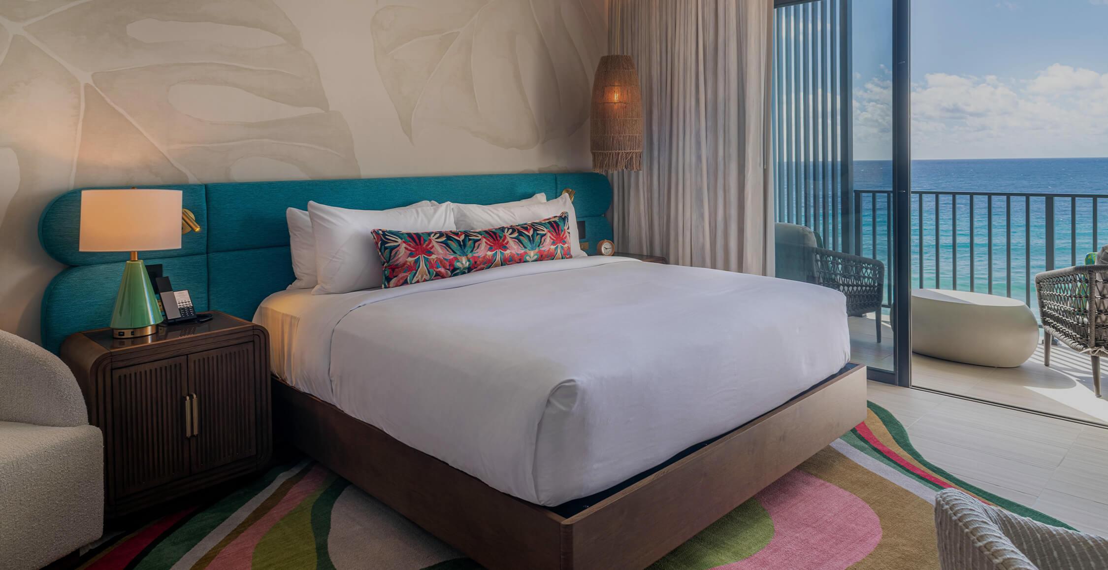 a bed with a blue headboard and white sheets