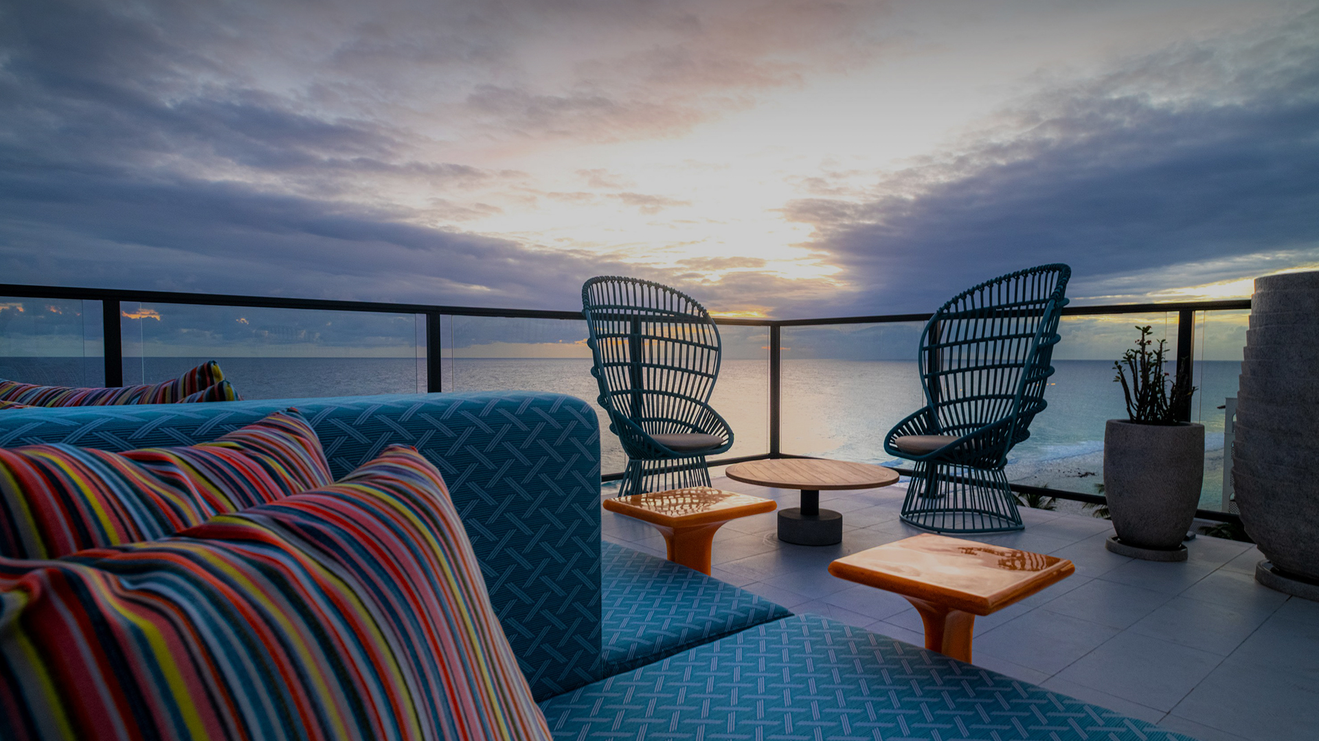 a deck with chairs and tables on a cloudy day