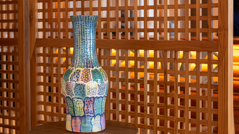 a colorful vase on a table