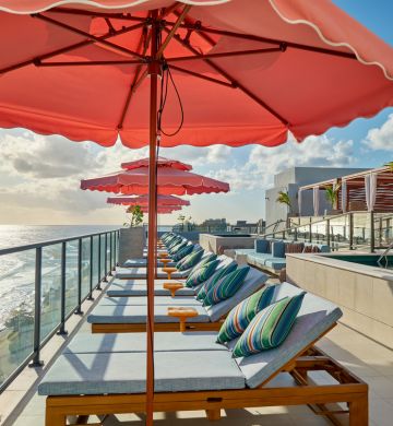 a deck chairs and umbrellas on a rooftop