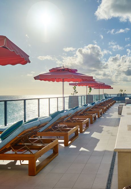 a row of chairs and umbrellas on a deck