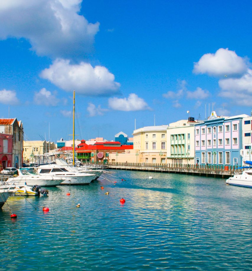 a water way with boats and buildings in the background