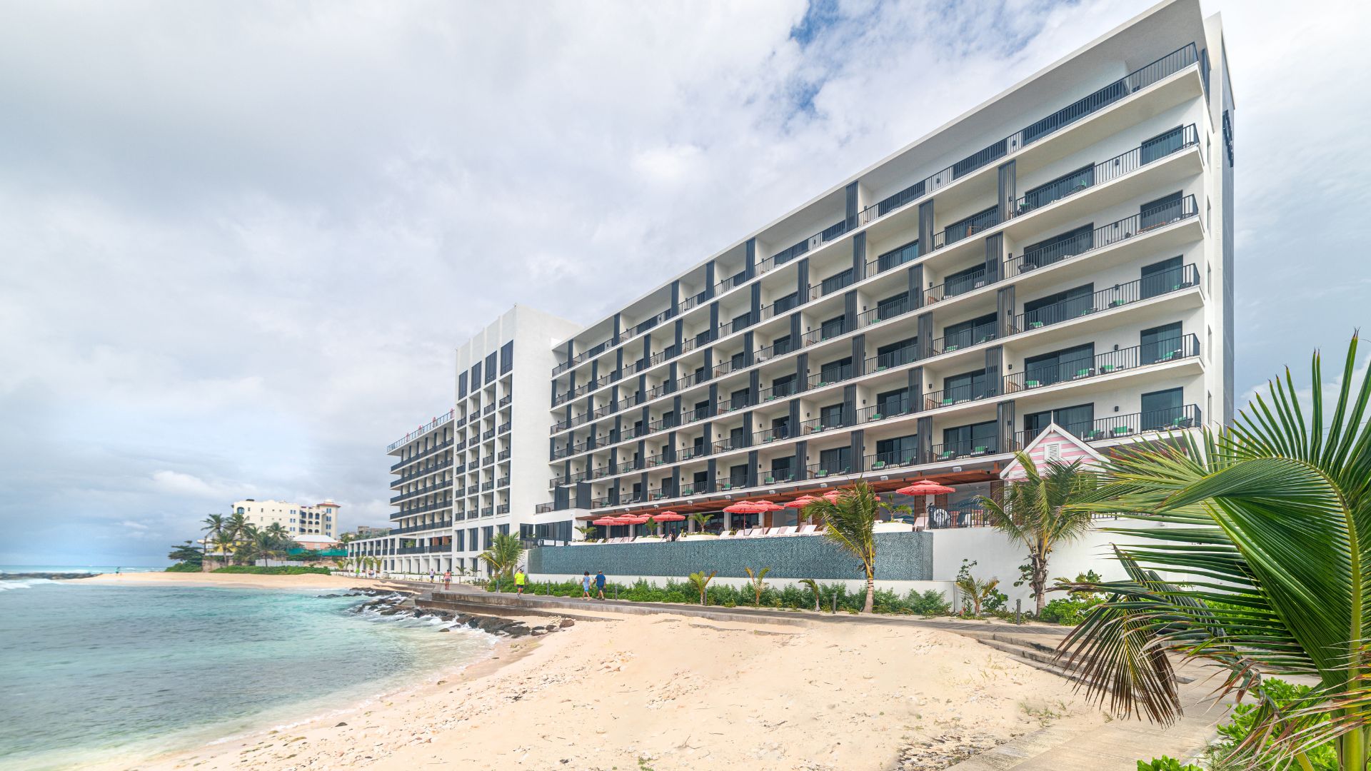 a large building with many windows and a beach