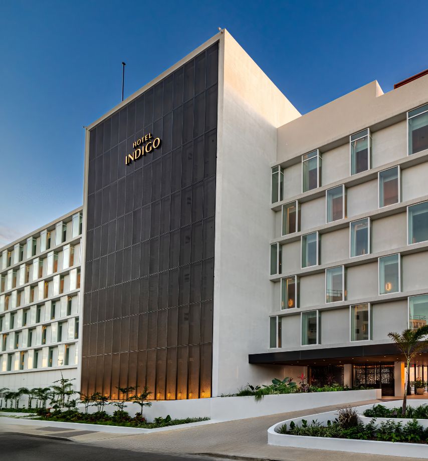a large white building with a black and gold sign