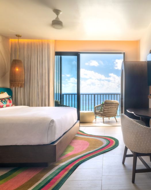 a room with a bed and a rug and a balcony