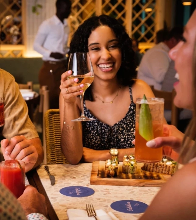 a woman holding a glass of wine