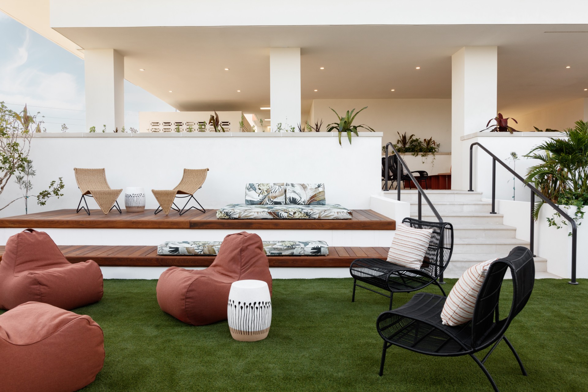 a patio area with chairs and a bed