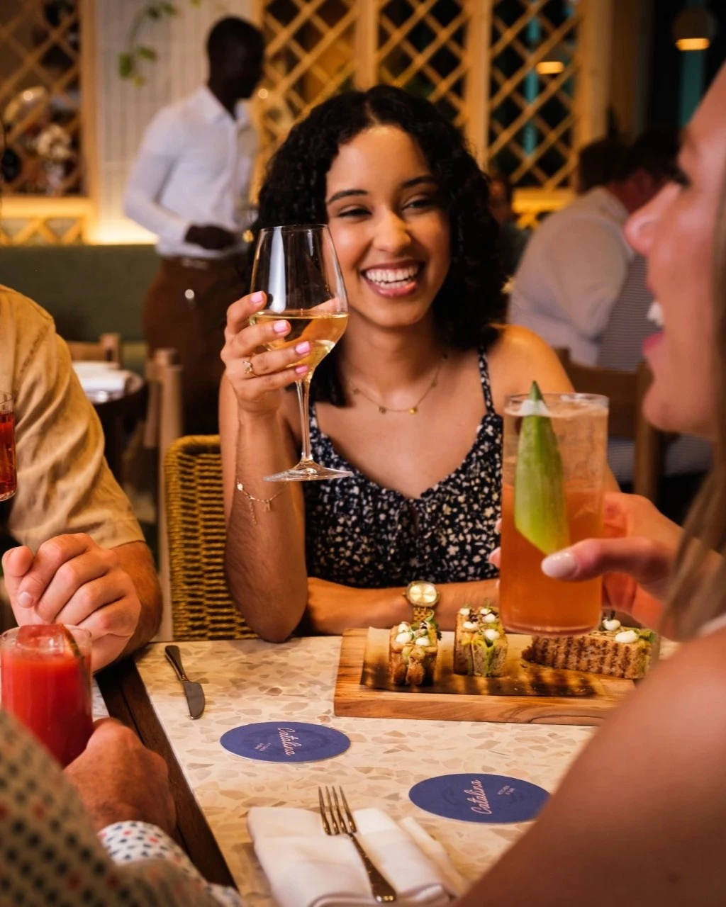 a group of people sitting at a table with drinks