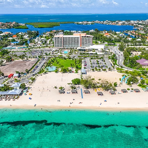 a beach with buildings and a body of water