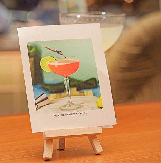 a picture of a drink on a small stand