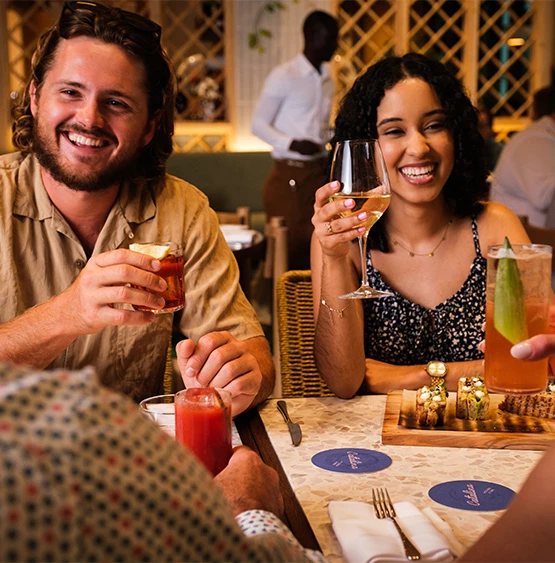 a group of people sitting at a table with drinks