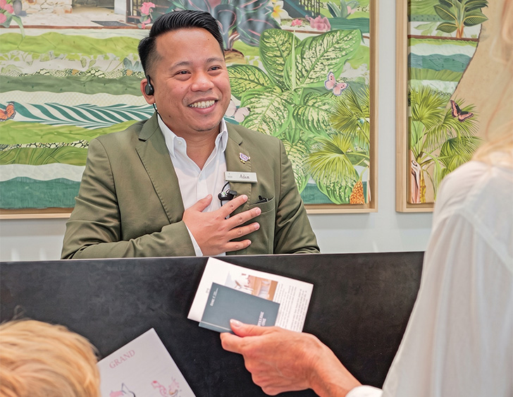 a man in a suit smiling at a woman
