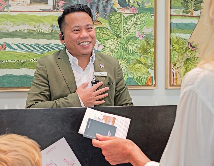 a man in a suit smiling at a woman