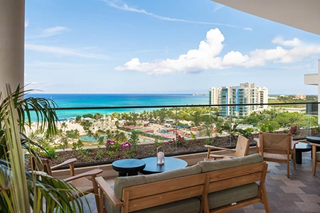 a balcony with a view of the ocean and a beach