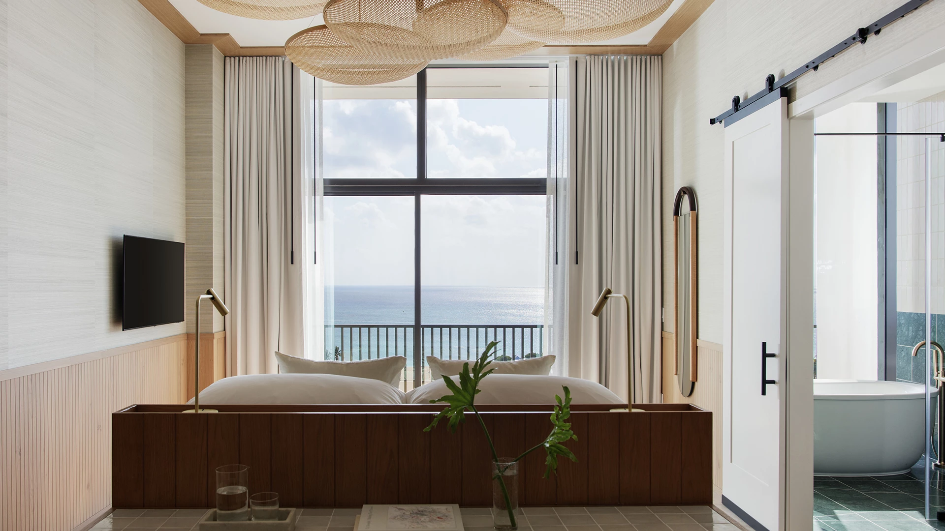 a room with a large window and a bed