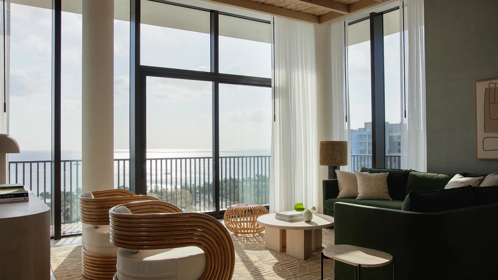 a living room with a large window overlooking the ocean