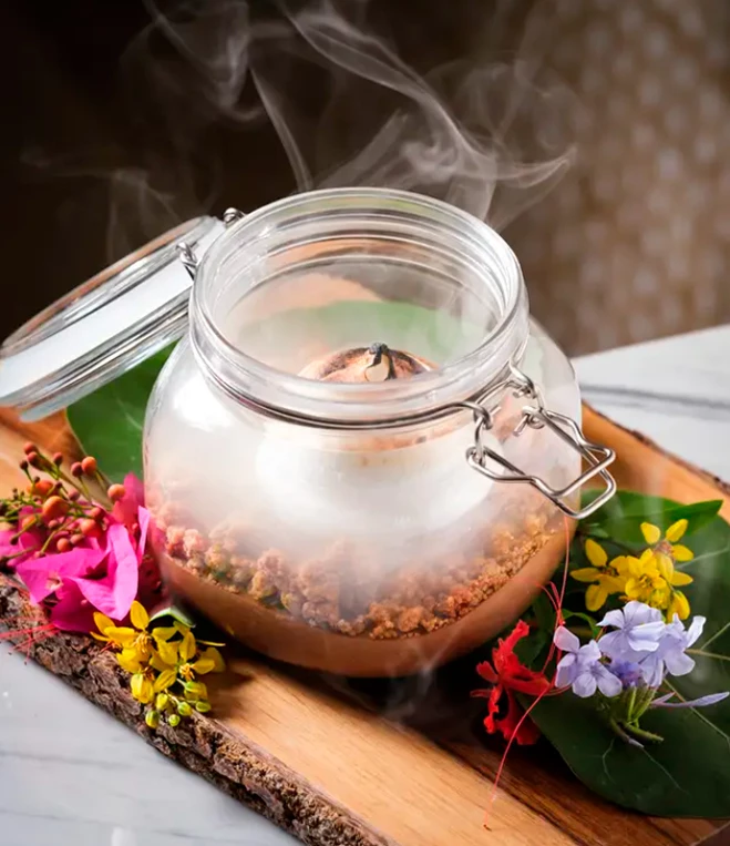 a glass jar with dessert and steam coming out