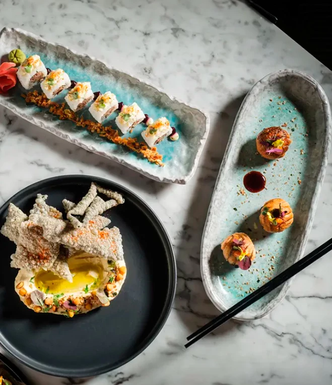 a plate of sushi on a marble table