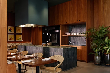 a kitchen with wood cabinets and tables