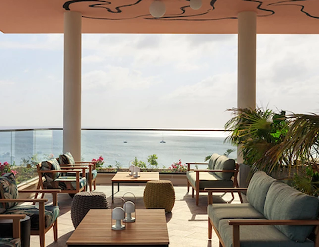 a patio with a view of the ocean and a boat