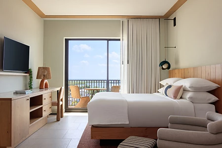 a bedroom with a large window and a balcony