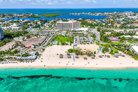 a beach with buildings and a body of water