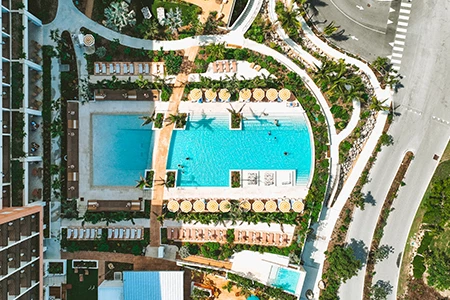 an aerial view of a pool and a road