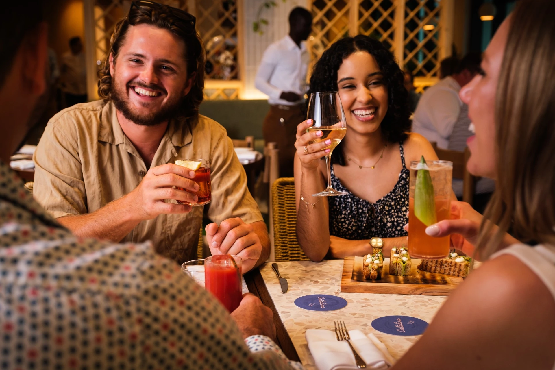 a group of people sitting at a table with drinks