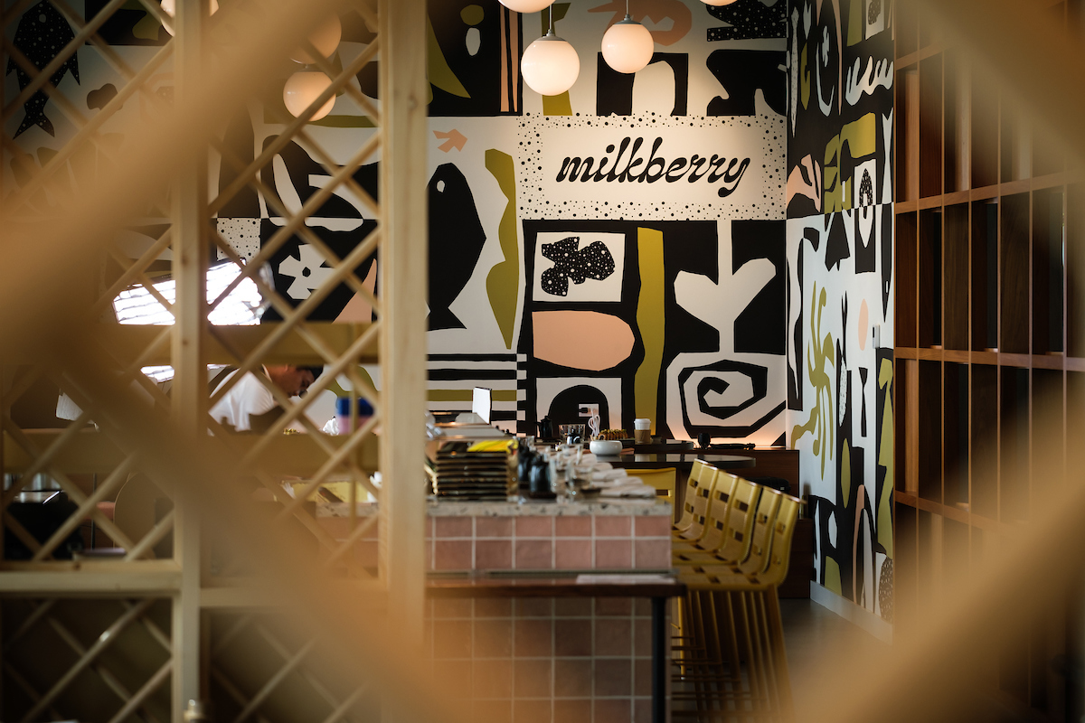 a room with a bar and chairs