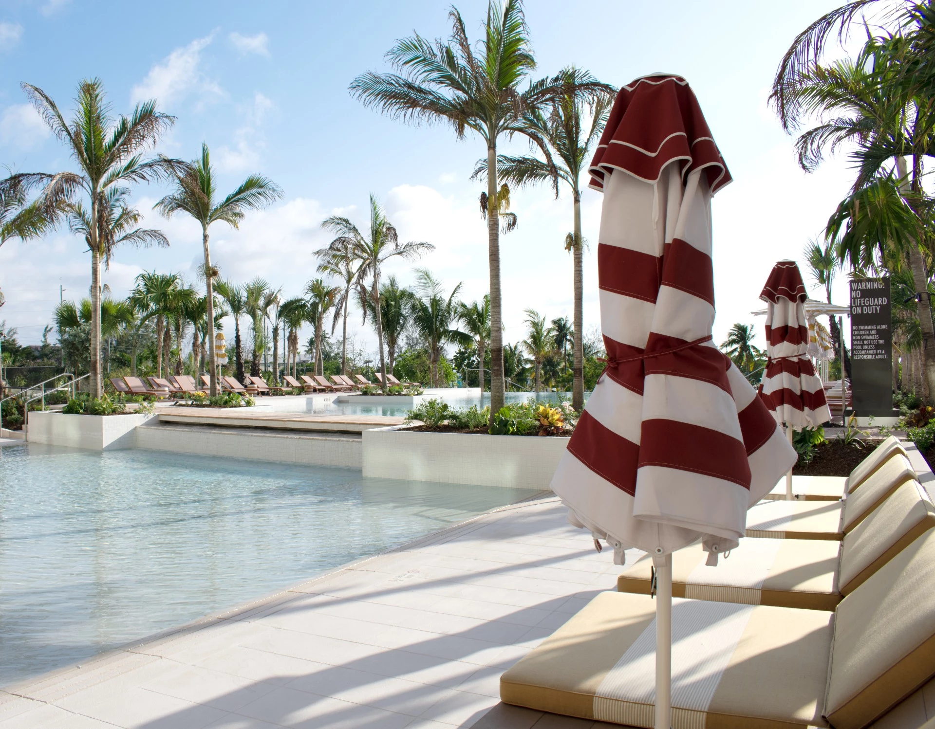 a pool with umbrellas and chairs
