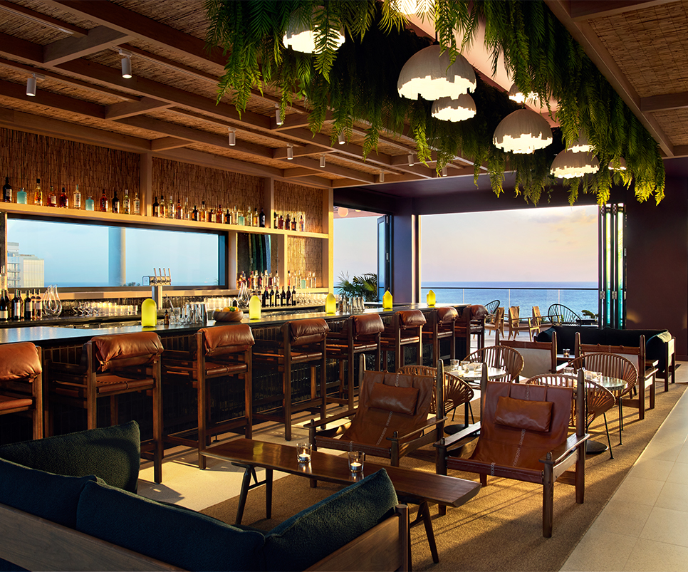 a room with a bar and chairs