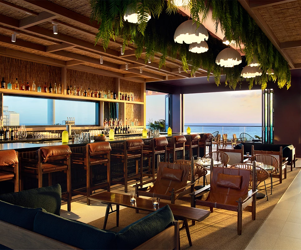 a room with a bar and chairs