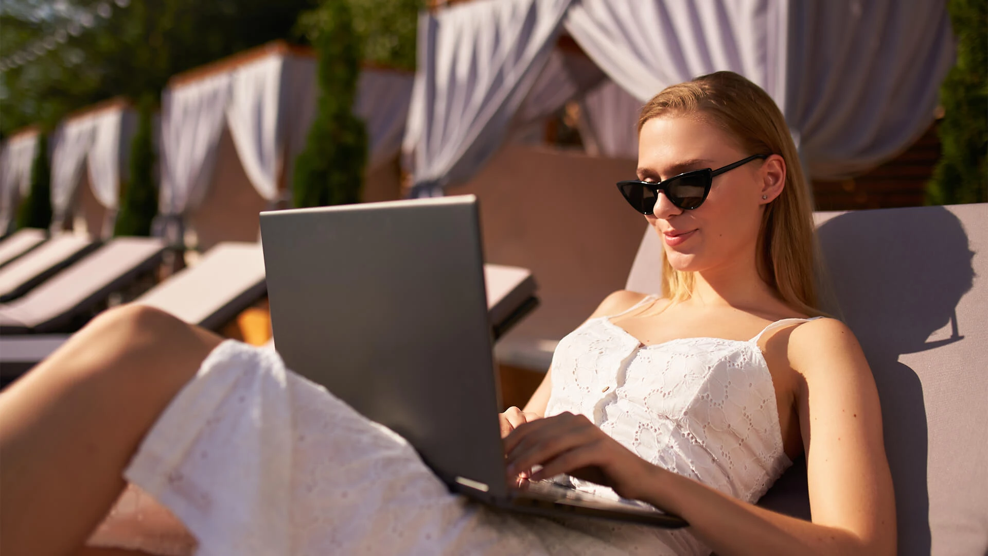 a woman sitting on a chair using a laptop