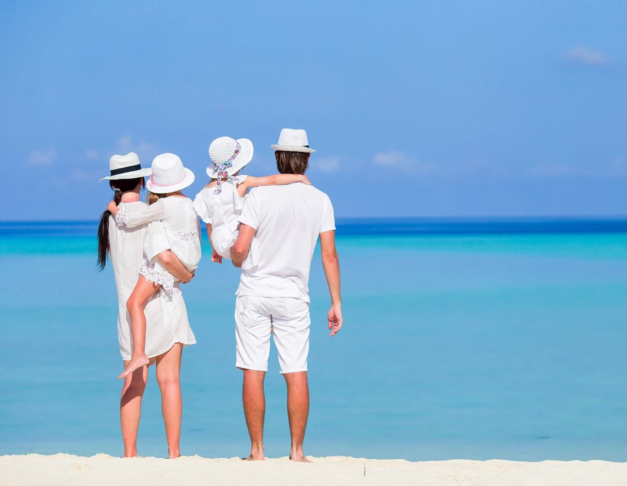a group of people standing on a beach