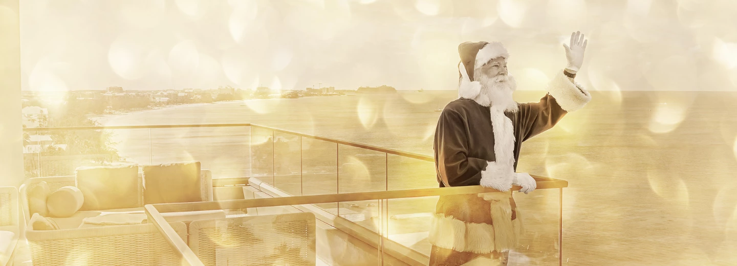 a man in a garment standing on a balcony overlooking a body of water