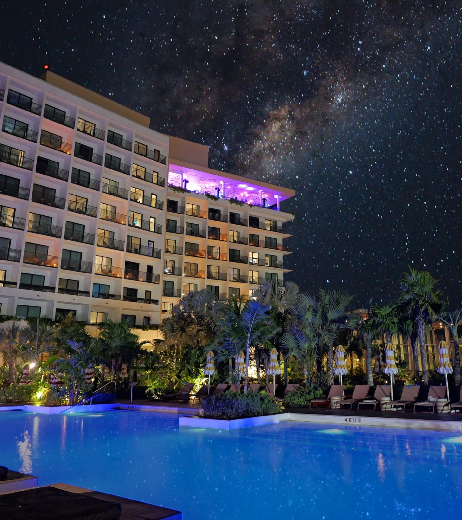 a pool and a building with a starry sky