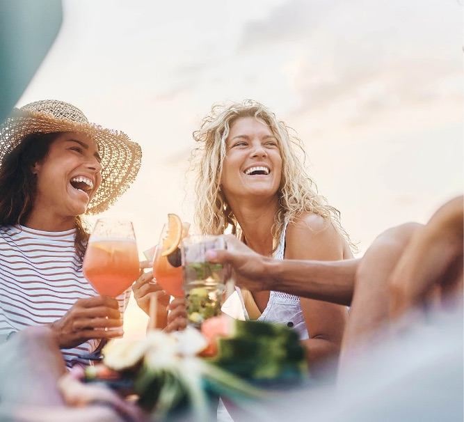 a group of people laughing and drinking