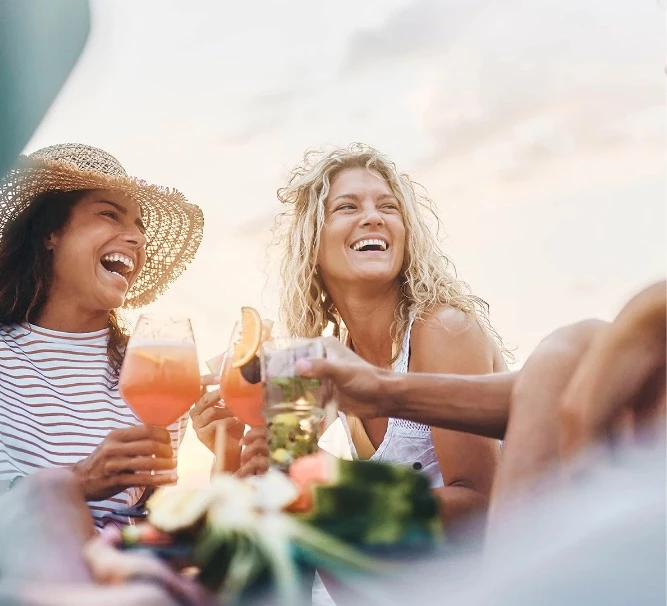 a group of people laughing and drinking