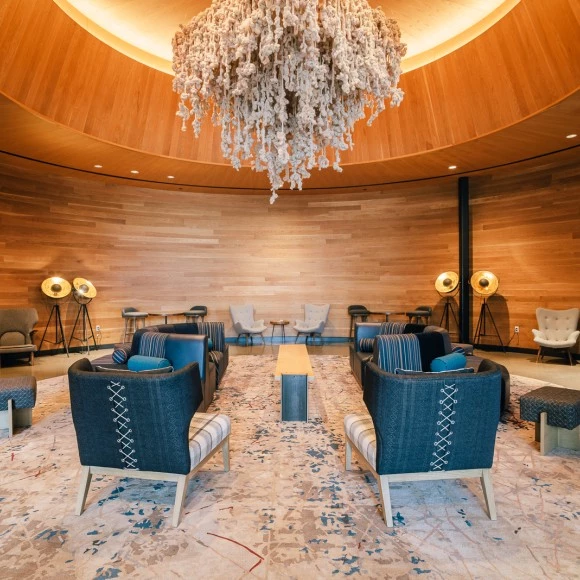 a room with chairs and a chandelier