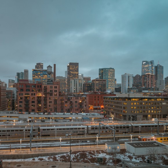 a city with a train in the distance