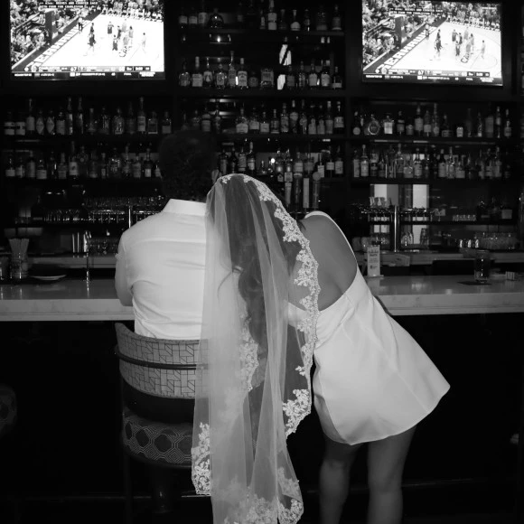 a bride and groom in a bar