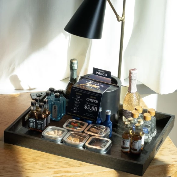 a tray with small bottles and a sign on it