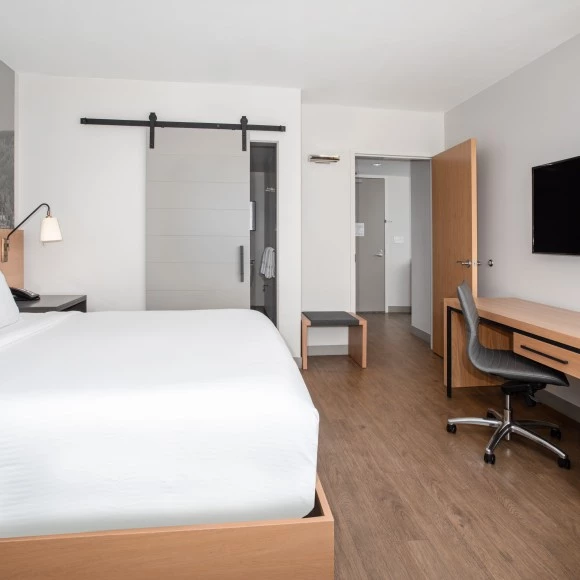 a room with a bed and desk