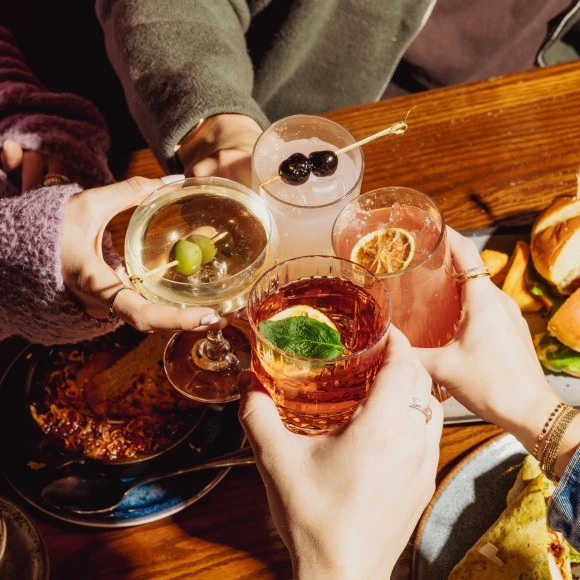 a group of people holding drinks