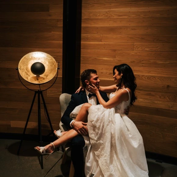 a man in a suit holding a woman in his lap