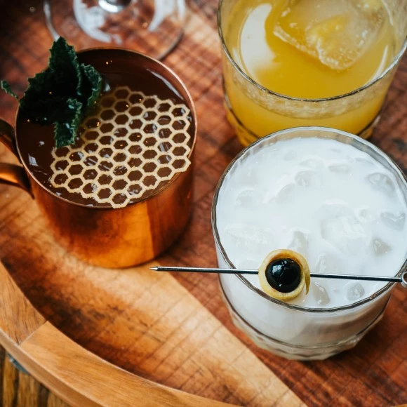 a tray of drinks on a wooden surface