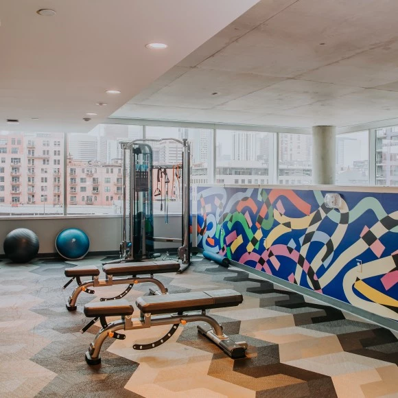 a gym with exercise equipment and a large window