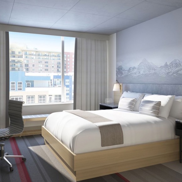 king bed with large window letting in bright sunshine